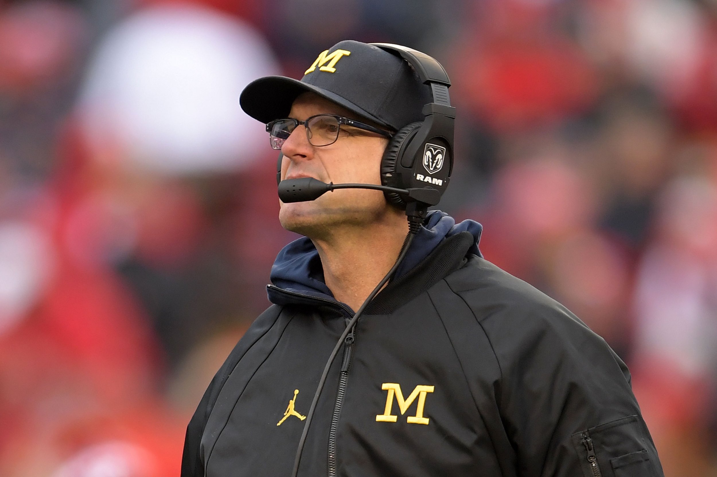 As NFL buzz begins, Jim Harbaugh says he'll be back at Michigan in