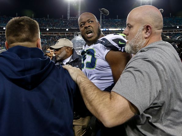 Seahawks' Quinton Jefferson tries to climb into stands to confront fans