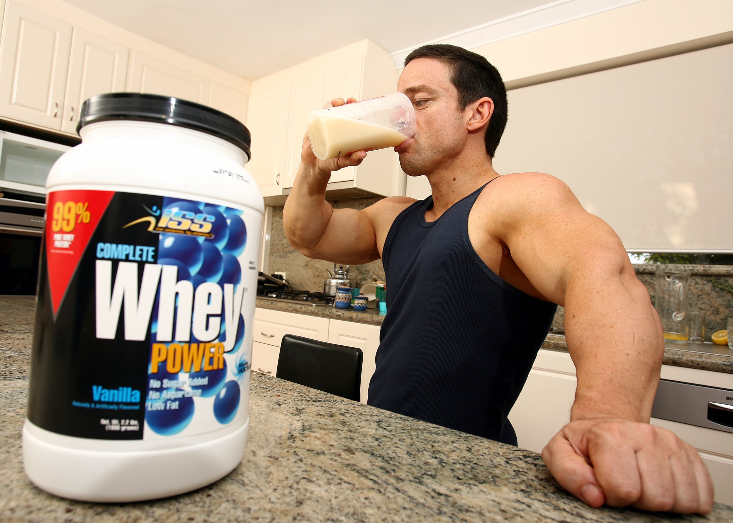 An Australian bodybuilder drinks a protein supplement shake. 