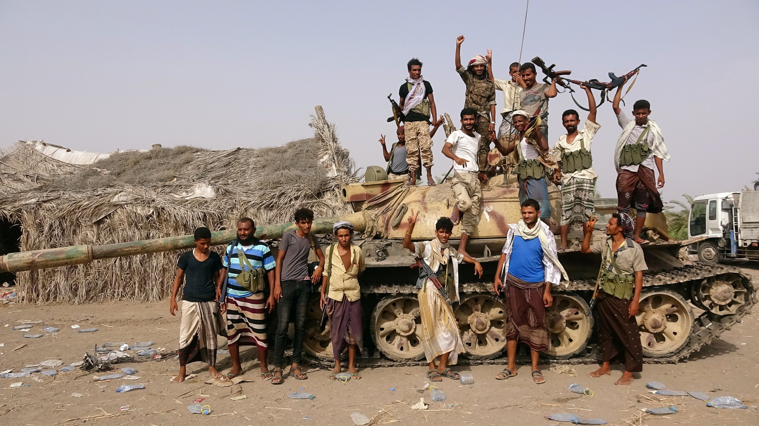 Tribal fighters loyal to the Yemeni government stand by a tank in al-Faza area near Hodeida, Yemen June 1, 2018. Picture taken June 1.
